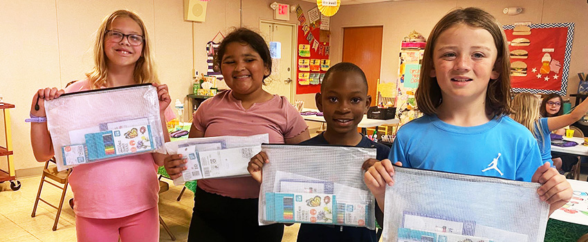 Kilby kids showing their bags