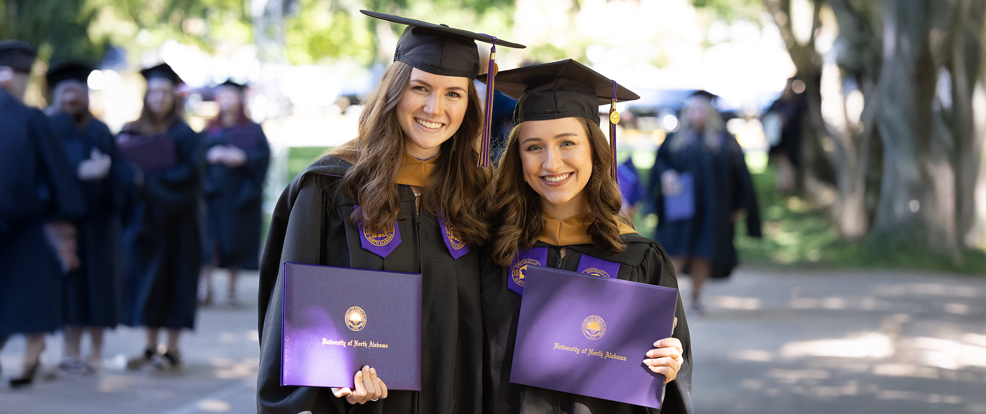 two students having just graduated higher education